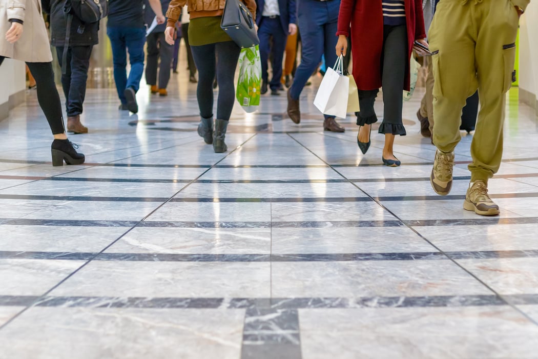 A modern floor with legs of a crowd in the background