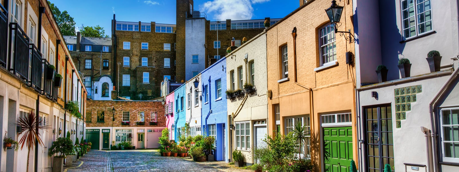 Brightly coloured mews houses along the alley of Conduit Mews, Paddington in London