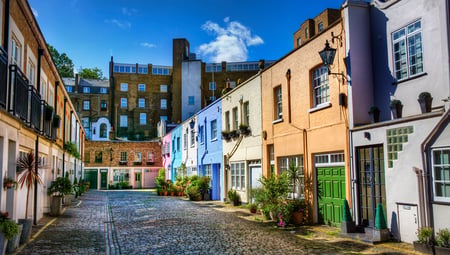 Brightly coloured mews houses along the alley of Conduit Mews, Paddington in London