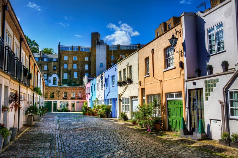 Brightly coloured mews houses along the alley of Conduit Mews, Paddington in London