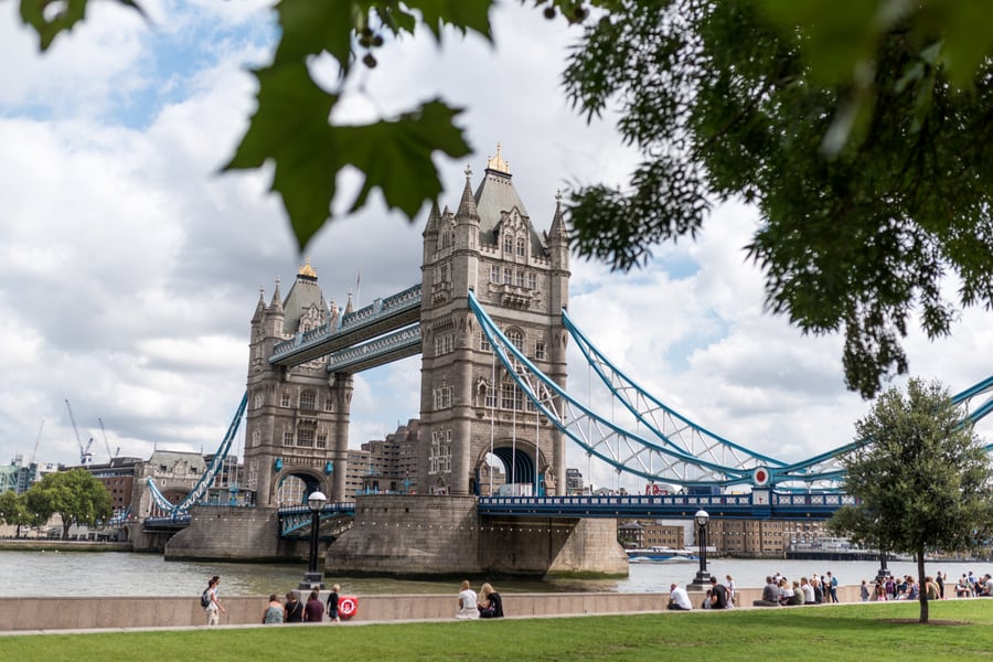 People sitting and enjoying the view of the iconic Tower Bridge